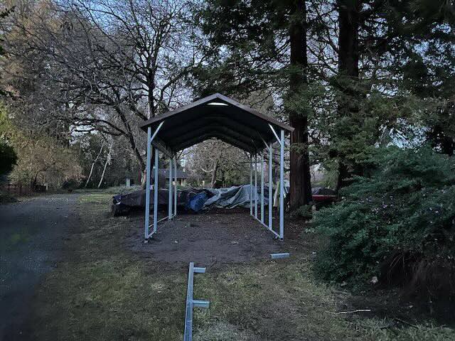 Single car carport on dirt foundation