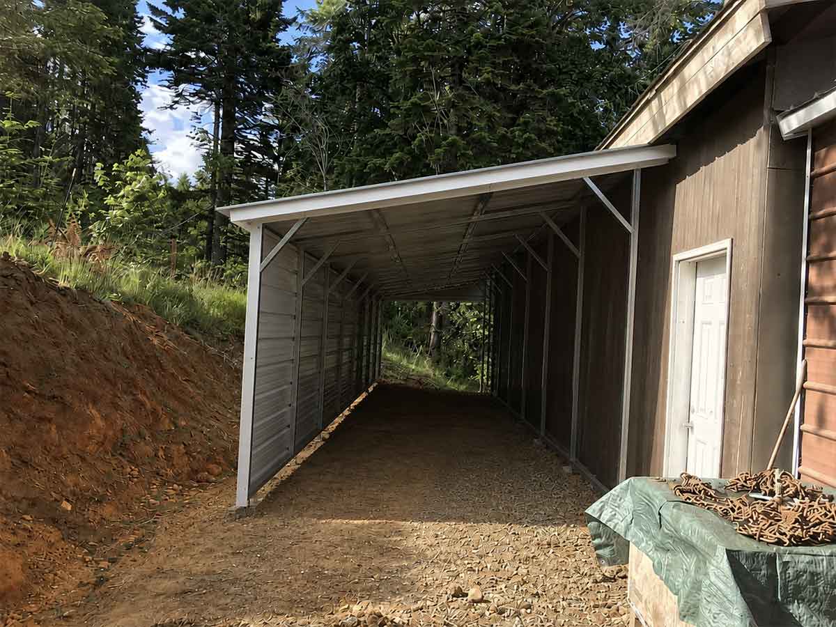 Completed lean-to metal structure covering the same property area